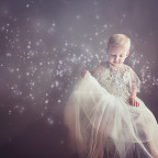 Child in beautiful white gown accented with the Milky Way constellation running across the image
