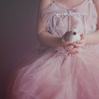 Image of little girl in pink dress holding dove