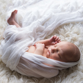 A newborn wrapped and sleeping peacefully